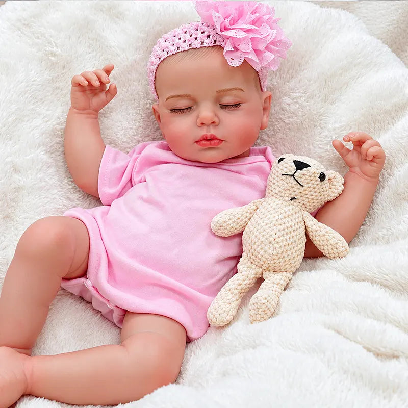 Pink Sleeping Reborn Baby Doll Resting with a Teddy Bear on a Soft Blanket