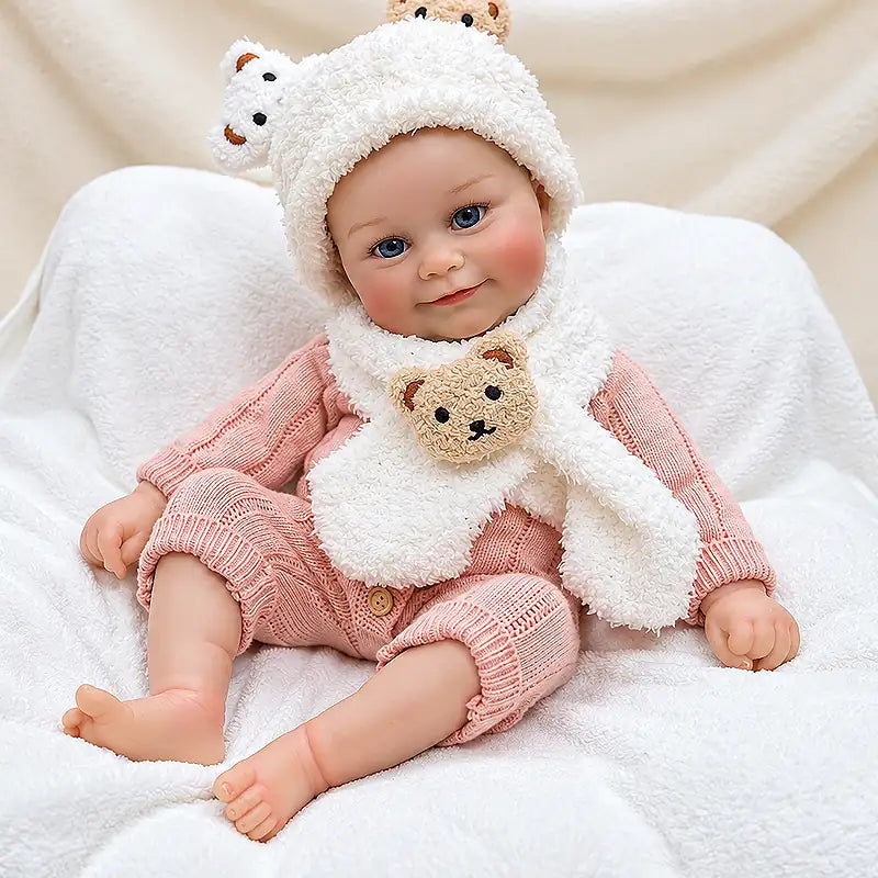 Realistic reborn doll with bright blue eyes, rosy cheeks, and a gentle smile.
