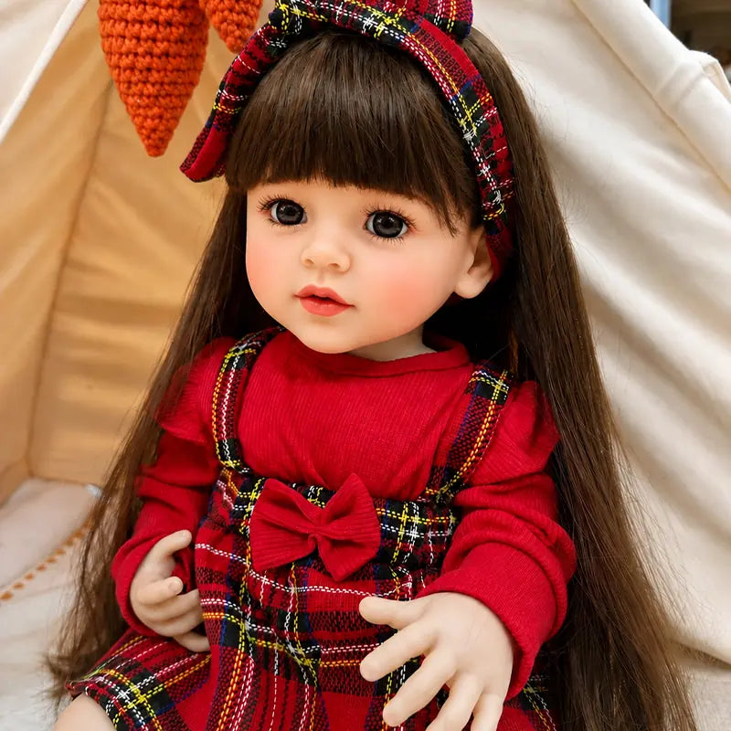 Lifelike reborn doll featuring large brown eyes, softly blushed cheeks, delicate lips, long straight hair, and detailed little hands.
