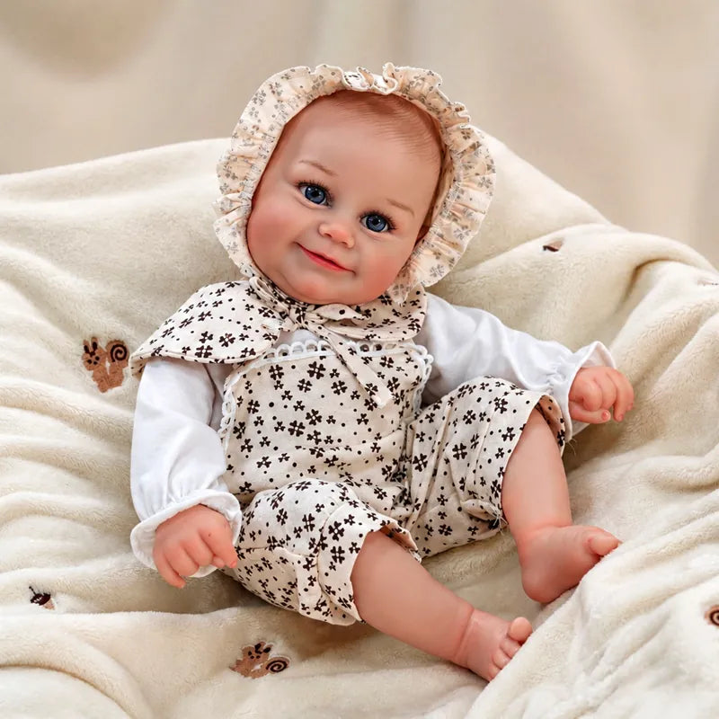 Realistic baby doll with bright blue eyes, rosy cheeks and a gentle smile.