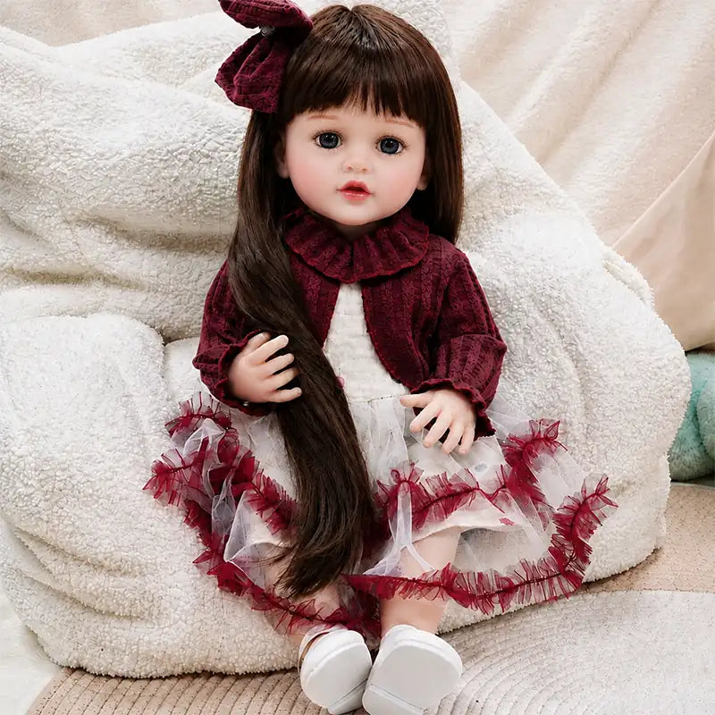 Handcrafted realistic reborn doll with finely painted skin details, carefully styled brown hair and detailed facial features designed for a lifelike appearance.