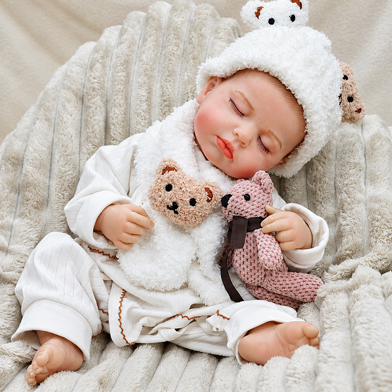 Adorable Ollie rests under a cozy blanket in a fluffy bear outfit, bringing warmth and playful charm to storytime, family photos, and nursery displays.