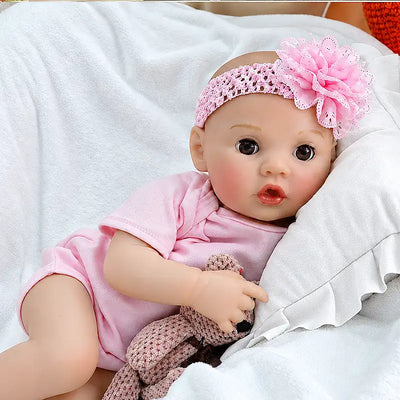 Maisie showcases fine eyelashes, glossy lips, natural baby coloring, realistic hands and feet, and carefully crafted clothing details for a lifelike appearance.