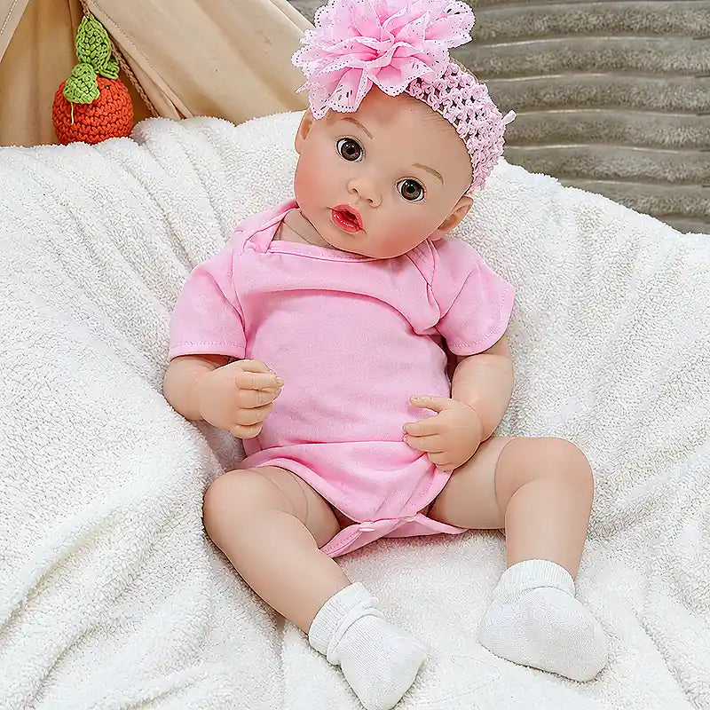 Maisie is ready for bottle time, cuddles, bedtime routines, and nursery play, featuring a sweet baby expression, detailed fingers, and a charming pink outfit.