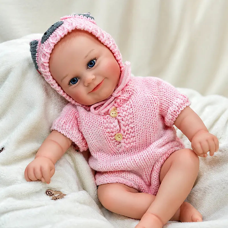 Cheerful Reborn Baby Doll Wearing a Pink Buttoned Romper and Matching Bonnet