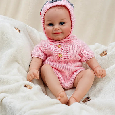 Smiling Soft Vinyl Reborn Baby Doll in a Pink Knitted Romper