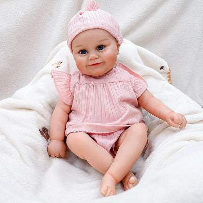 Eliza wearing a pink ribbed fabric outfit with flutter sleeves and a matching knotted baby hat.