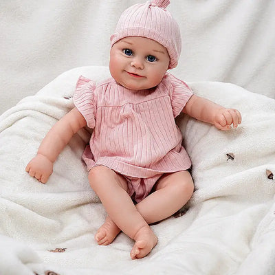 Eliza reborn baby doll with lifelike blue eyes, rosy cheeks, and a sweet smiling expression.