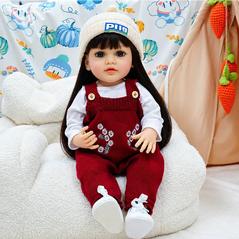 Charlotte features delicate eyelashes, natural facial coloring, long silky hair, and textured knitted clothing with floral embroidery, making her a charming collectible for doll lovers.