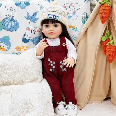 Sweet Charlotte combines lifelike facial details, realistic hands, soft-looking vinyl or silicone-style craftsmanship, and adorable seasonal clothing for a warm, playful look.