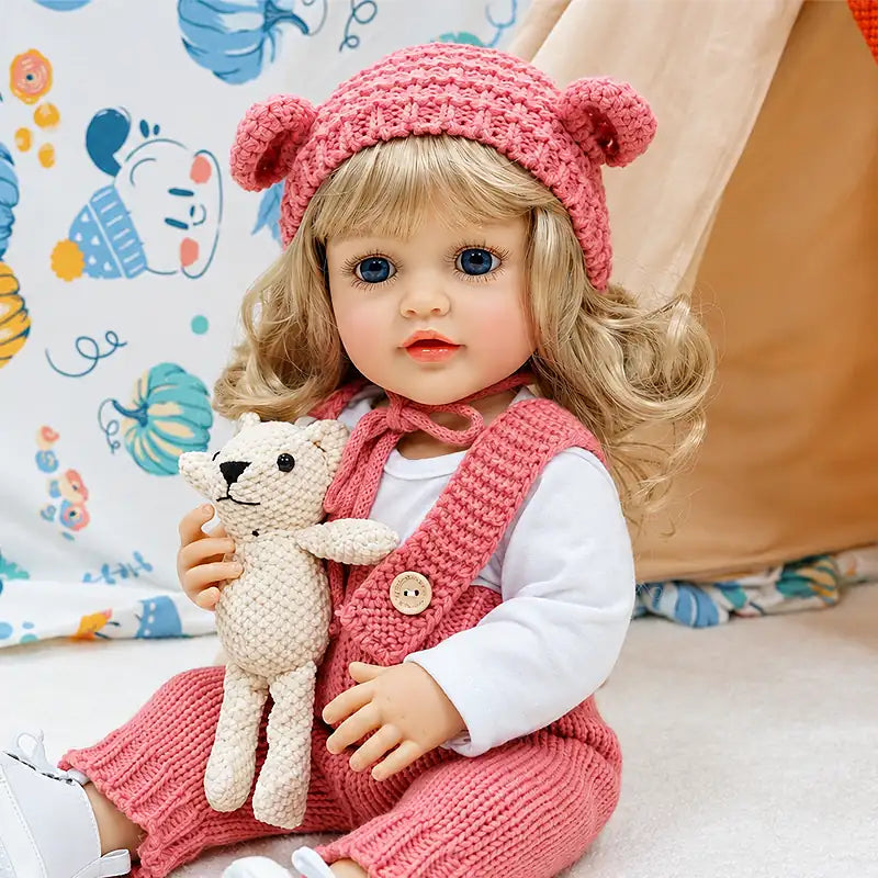 Isabella features carefully painted facial details, realistic eyelashes, soft-looking vinyl or silicone-style craftsmanship, curly blonde hair, and charming pink clothing.