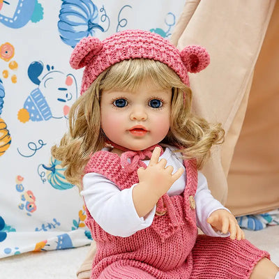 Isabella brings storybook charm to any playroom with her bear hat, pink romper, white shoes, curly hair, and lifelike baby expression.