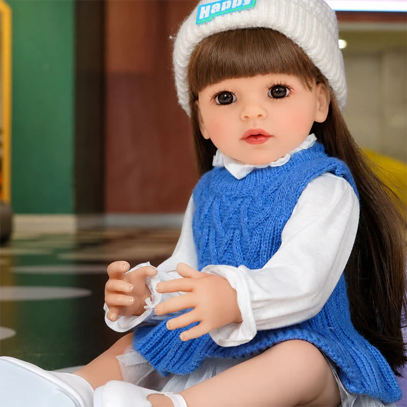 Lifelike reborn girl doll dressed in blue, perfect for pretend play, tea parties, dress-up games, and everyday storytelling.