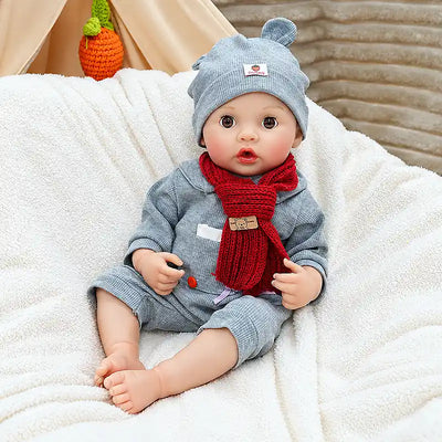 Lifelike Clara showcases delicate hands, rounded baby feet, fine eyelashes, glossy lips, and textured knit accessories for a cozy handmade look.