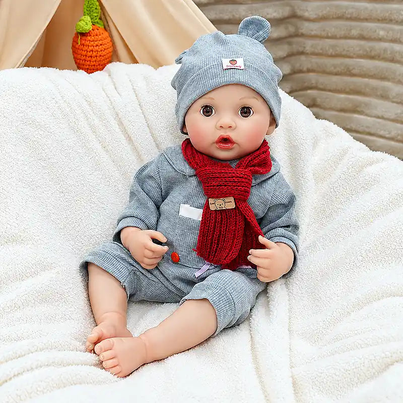 Lifelike Clara showcases delicate hands, rounded baby feet, fine eyelashes, glossy lips, and textured knit accessories for a cozy handmade look.