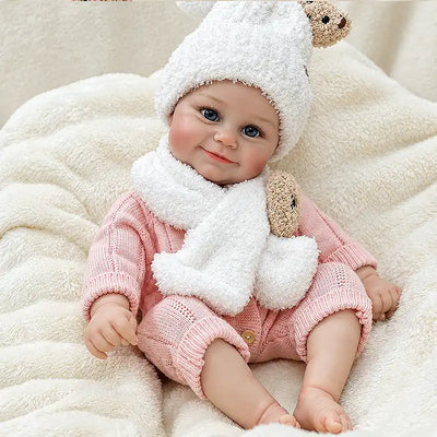 Bear-themed reborn doll in a pink outfit, ready for make-believe story time.