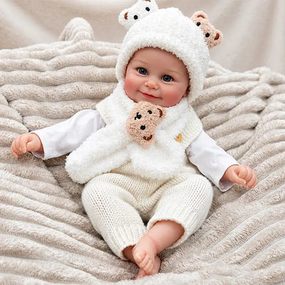 Cheerful Reborn Baby Doll Wearing a Fluffy Bear Hat, Scarf and Knitted Trousers
