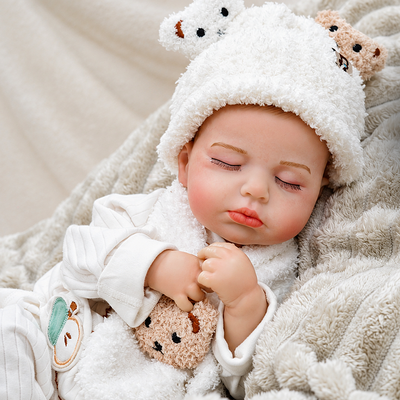 Ollie showcases realistic baby proportions, delicate hands and feet, fine eyelashes, carefully crafted details, and a charming bear-inspired nursery style.