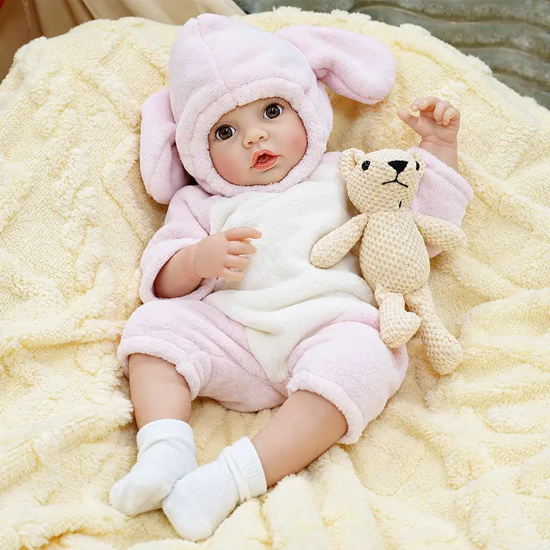 Ella features bright brown eyes, glossy lips, natural baby coloring, detailed hands and feet, and carefully crafted reborn details for an engaging feeding experience.