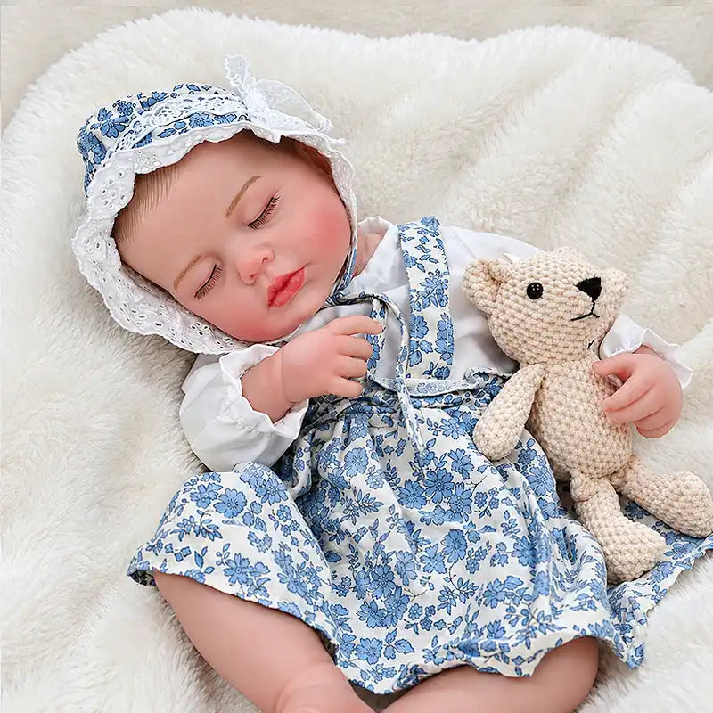 Realistic Reborn Baby Doll Resting on a Soft White Blanket