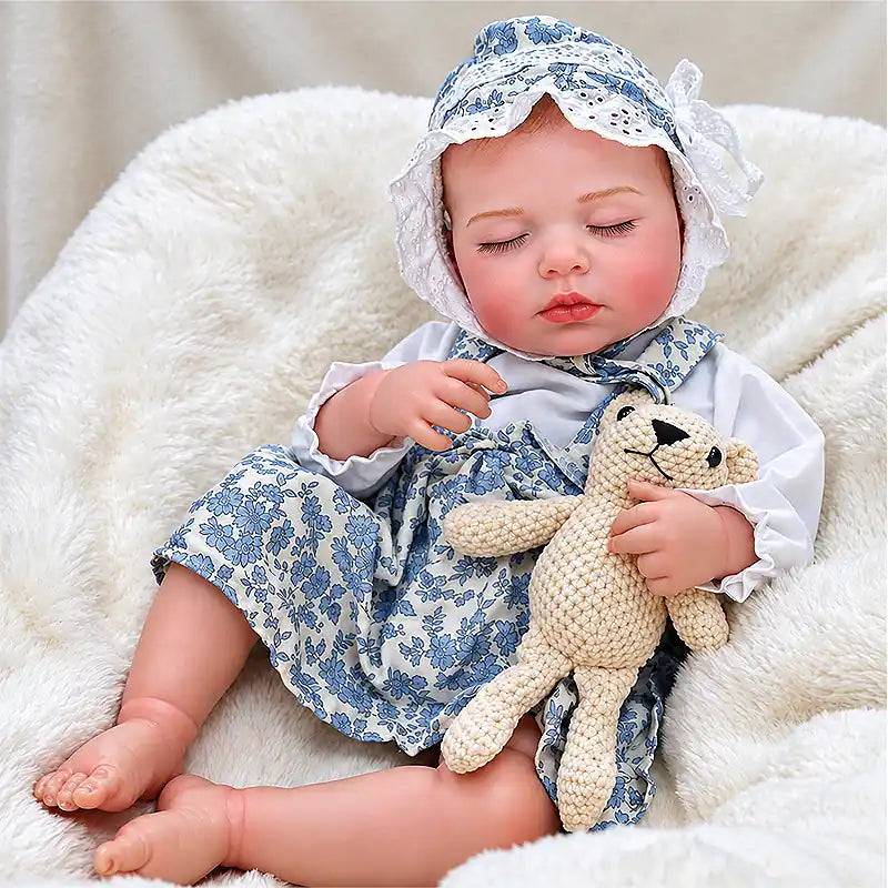 Realistic Sleeping Baby Doll Wearing a Blue Floral Dress and Matching Bonnet