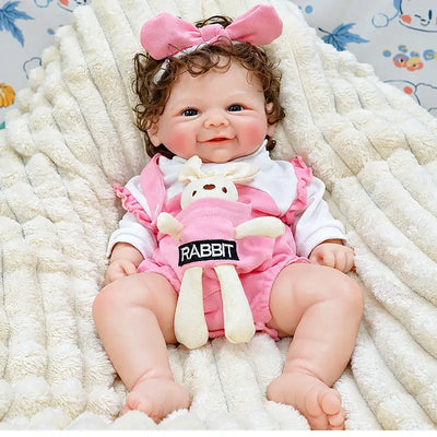 Layla brings fun to any playroom with her pink clothes, oversized bow, soft bunny accessory, and happy baby expression, ideal for birthdays and Christmas.
