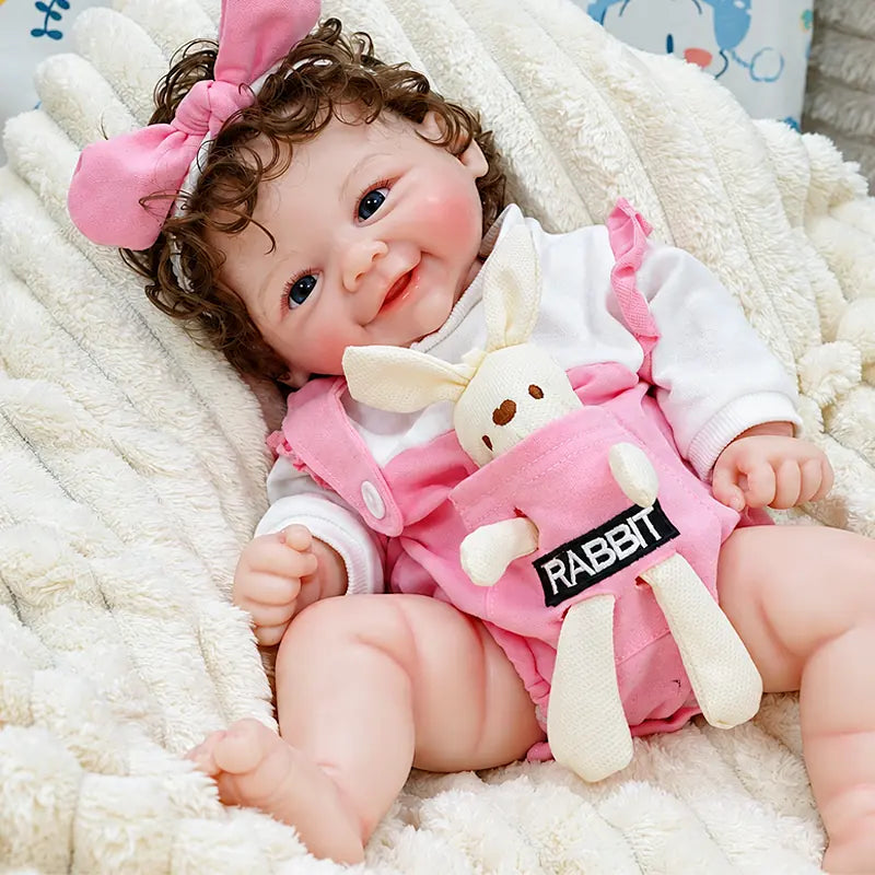 Layla showcases realistic facial painting, detailed hands, curly rooted hair, and a soft silicone finish, making her a charming choice for collectors and doll lovers.