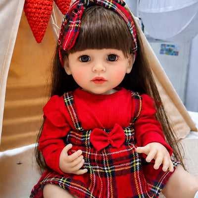 Soft vinyl reborn baby doll crafted with realistic skin tones, finely painted facial details, smooth limbs, and carefully styled long brown hair.