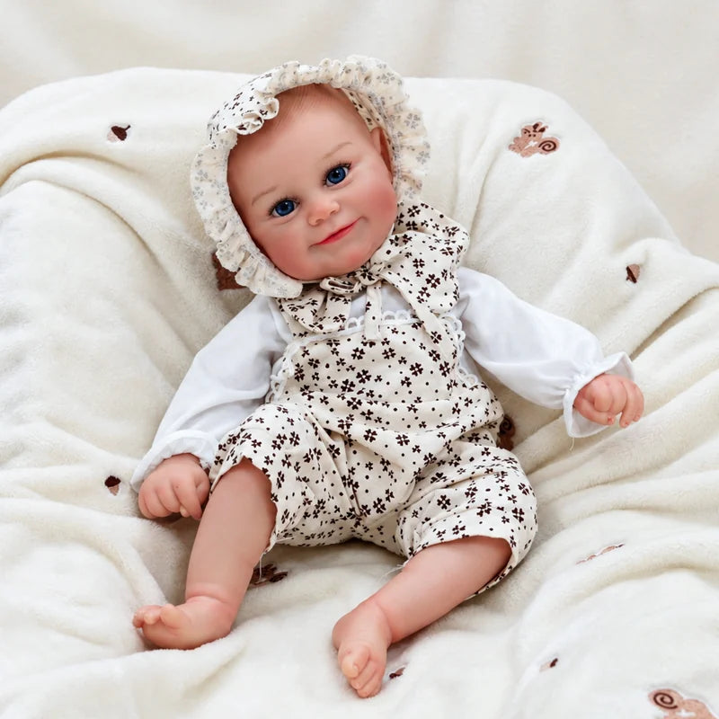 Smiling Baby Doll in a floral bonnet and matching romper, sitting on a soft cream blanket.