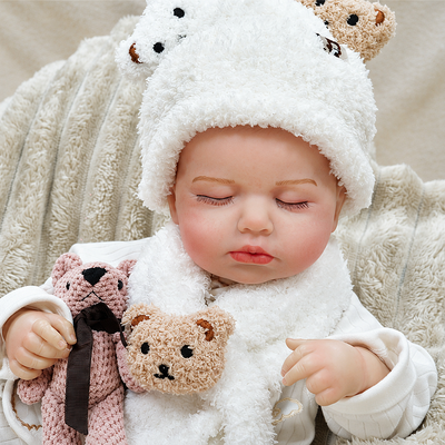Sweet Ollie wears a soft white bear romper and cuddles a teddy friend, making him ideal for nurturing role play, bedtime routines, collectors, and gift giving.