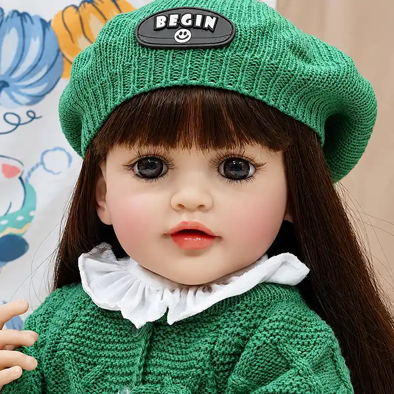 Amelia reborn baby doll with rosy cheeks, glossy lips, soft facial details, and handmade green knit clothing, perfect for pretend play, cuddles, and doll collections.