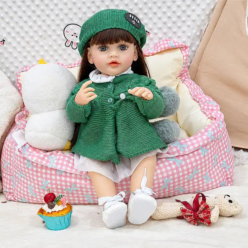 Amelia brings playful charm to any nursery with her rosy cheeks, delicate facial features, detailed hands, long hair, and adorable green knitted outfit.