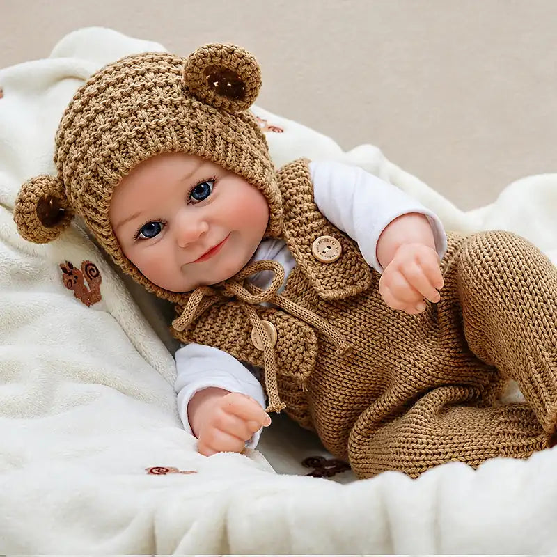 Reborn baby doll in a matching bear hat 