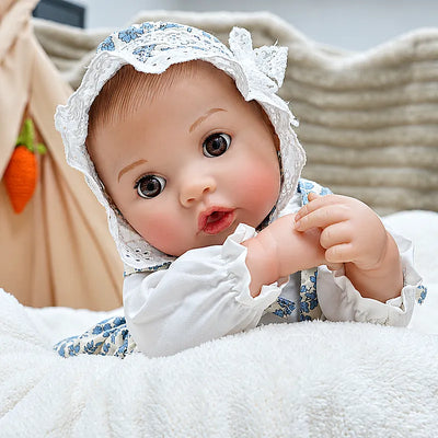 Adorable Ellis wears a vintage-inspired floral bonnet and matching outfit, holding a teddy bear and ready for storytime, tea parties, and nurturing play.