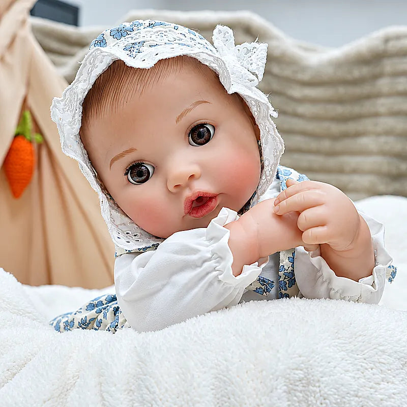 Adorable Ellis wears a vintage-inspired floral bonnet and matching outfit, holding a teddy bear and ready for storytime, tea parties, and nurturing play.