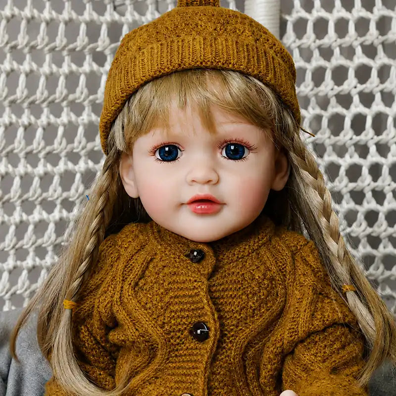 Lifelike reborn doll featuring vivid blue eyes, softly blushed cheeks, delicate lips, and finely detailed facial features.