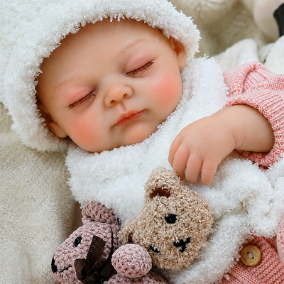 Lifelike reborn sleeping baby doll with delicate skin tones, rosy cheeks, tiny fingers, and realistic newborn-inspired features.