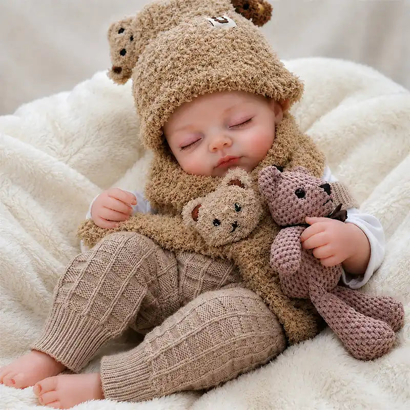 Cozy reborn baby doll resting with a teddy bear, perfect for nursery displays, pretend play, photography, gifting, and doll collections.