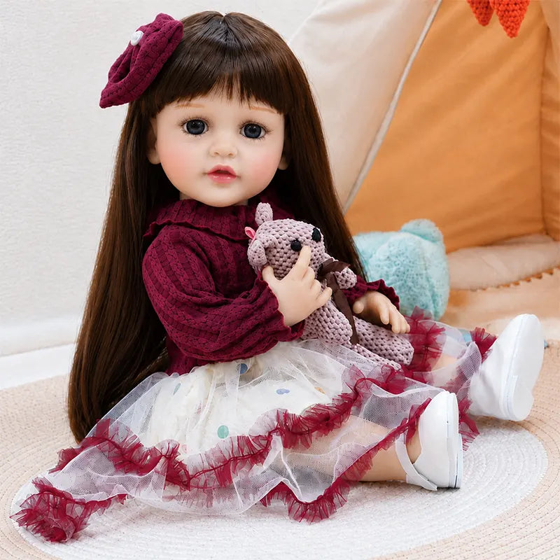 Close-up details of a realistic reborn girl doll featuring bright eyes, delicate eyelashes, rosy cheeks, natural pink lips and a sweet childlike expression.