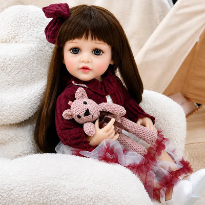 Lifelike reborn doll dressed in a burgundy outfit, perfect for pretend parenting, tea parties, nursery play, birthday gifts and Christmas surprises.