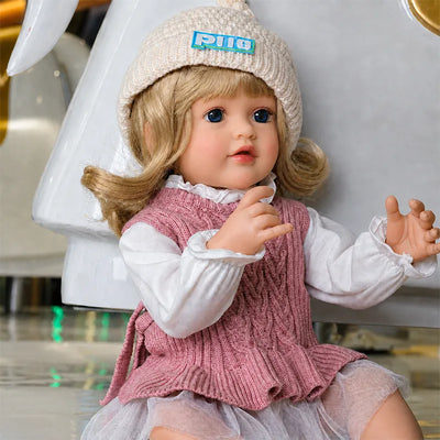 Handcrafted lifelike reborn doll with finely painted skin details, realistic facial features, carefully styled hair, and detailed clothing.