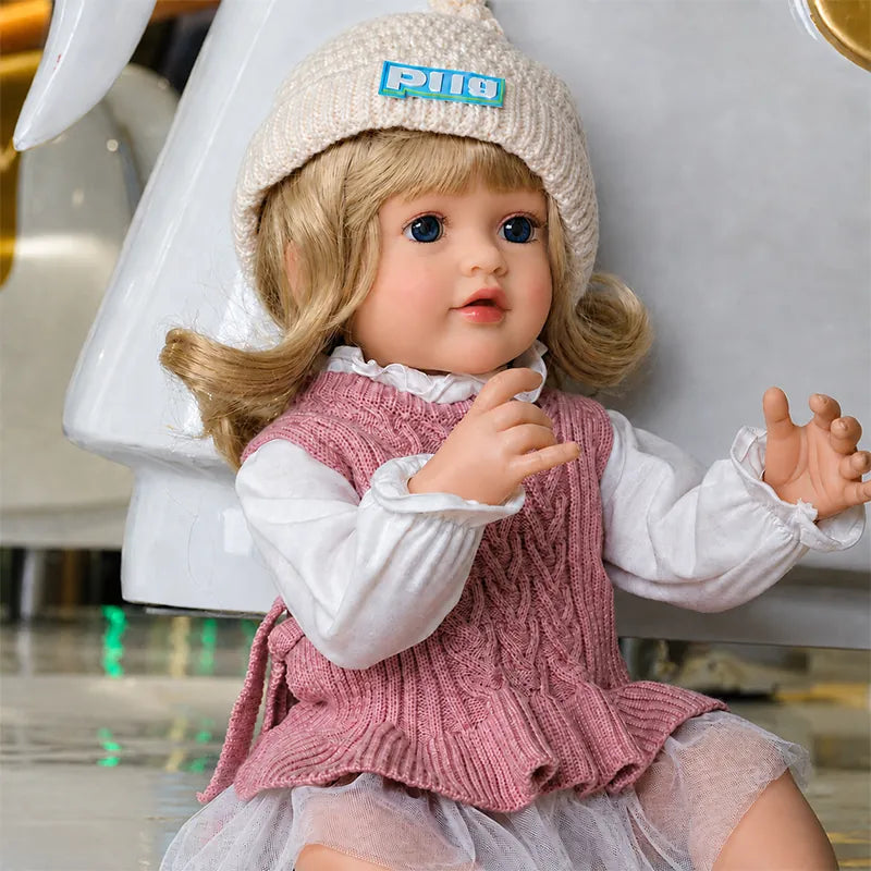 Handcrafted lifelike reborn doll with finely painted skin details, realistic facial features, carefully styled hair, and detailed clothing.