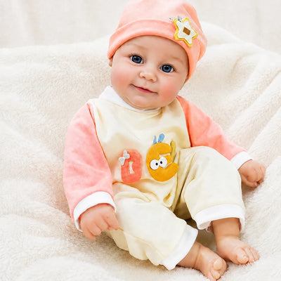 Lifelike reborn baby doll relaxing on a soft nursery blanket, a charming companion for pretend play, doll collecting, holiday gifting, and cozy family moments.
