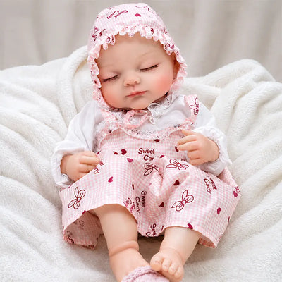 Realistic reborn newborn doll lying in a cozy nursery basket with fluffy blankets, creating a sweet and peaceful baby-care play scene.